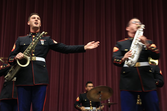Sergeant Spencer Day garners applause for Lance Cpl. Joseph DeLaGarza after a solo performance at Eureka High School, Dec. 14, in Eureka, Missouri. Marines with the Marine Corps New Orleans Band entertained students and teachers at various high schools in and around the St. Louis area Dec. 12-14 during its winter recruiting tour. Aside from playing music, the New Orleans, Louisiana-based Marines also educated and informed students and teachers about what life is like being a band Marine. (Official U.S. Marine Corps photo by GySgt. Bryan A. Peterson/Released)