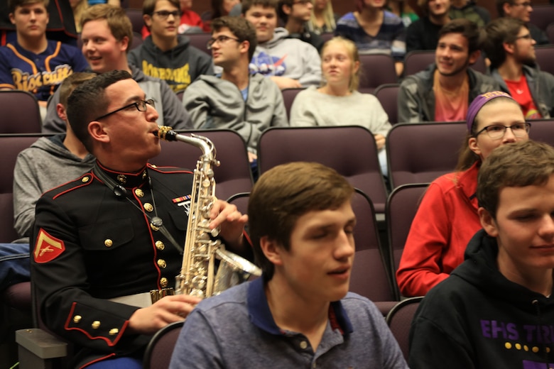 Lance Cpl. Joseph DeLaGarza plays his saxophone amongst Eureka High School students, Dec. 14, in Eureka, Missouri. Marines with the Marine Corps New Orleans Band entertained students and teachers at various high schools in and around the St. Louis area Dec. 12-14 during its winter recruiting tour. Aside from playing music, the New Orleans, Louisiana-based Marines also educated and informed students and teachers about what life is like being a band Marine. (Official U.S. Marine Corps photo by GySgt. Bryan A. Peterson/Released)