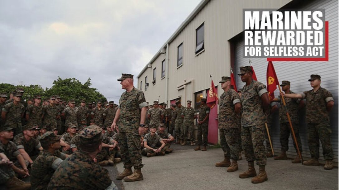 Lt. Gen. Lawrence Nicholson recognizes Sgt. Arthur Whittaker and Staff Sgt. Nathanial Clark for their selfless acts of care, Dec. 14, 2017, at Marine Corps Base Hawaii. On their way to Guam, the Marines attended to an elderly man who was traveling alone and appeared to be disoriented and disabled. Whittaker and Clark spent the rest of the seven hour flight caring for him. Nicholson is the III Marine Expeditionary Force commanding general and Okinawa Area Coordinator. Whittaker, a native of Fredericksburg, Virginia, is an electrical optical ordnance technician with Combat Logistics Battalion 3, 3d Marine Logistics Group. Clark, a native of Lakeville, Minnesota, is a ground communication maintenance technician with Combat Logistics Battalion 3, 3d Marine Logistics Group. (U.S. Marine Corps photo by Sgt. Kathy Nunez)