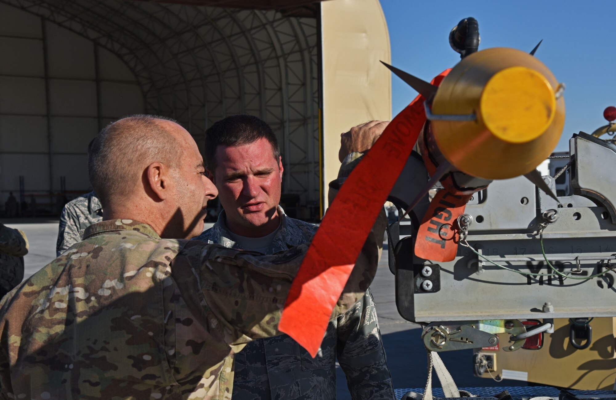 U.S. Air Force Lt. Gen. Jeffery Harrigian, U.S. Air Forces Central Command Commander, talks with Master. Sgt. Robert Brown, 100th Expeditionary Fighter Squadron Munitions Production superintendent, at the 407th Air Expeditionary Group in Southwest Asia, Dec. 14, 2017. Brown talked about the F-16 Fight Falcon’s weapon systems and the capability of the missile. (U.S. Air Force photo by Staff Sgt. Joshua Edwards/Released)