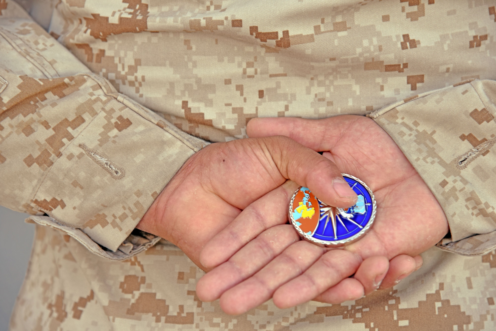 A 9th Air Expeditionary Task Force-Levant Marine holds an U.S. Air Forces Central Command’s Commander coin, at the 407th Air Expeditionary Group in Southwest Asia, Dec. 14, 2017. U.S. Air Force Lt. Gen. Jeffery Harrigian, U.S. Air Forces Central Command Commander, gave the Marine the coin for being one of the 407th Air Expeditionary Group’s top performers. (U.S. Air Force photo by Staff Sgt. Joshua Edwards/Released)