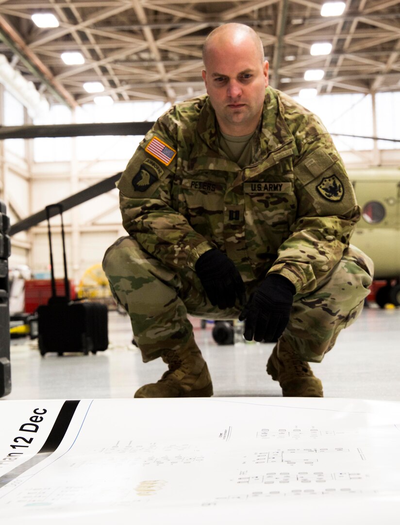 FT. Eustis, Va. -- Capt. John Peters, battle captain, Joint Task force Civil Support looks over a layout plan for the Joint Operations Center Exercise December 12, 2017.JTF-CS provides command and control for designated Department of Defense specialized response forces to assist local, state, federal and tribal partners in saving lives, preventing further injury, and providing critical support to enable community recovery.