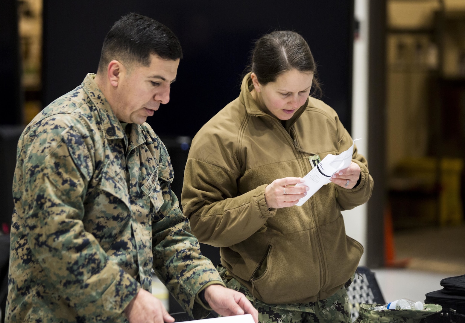Staff Sgt. Hector Ochoa, current operations non commissioned officer in charge, Joint Task Force Civil Support and Lt. Cristine Sickal, administrative officer, JTF-CS set up a workspace during a Joint Operations Center Exercise December 13, 2017.