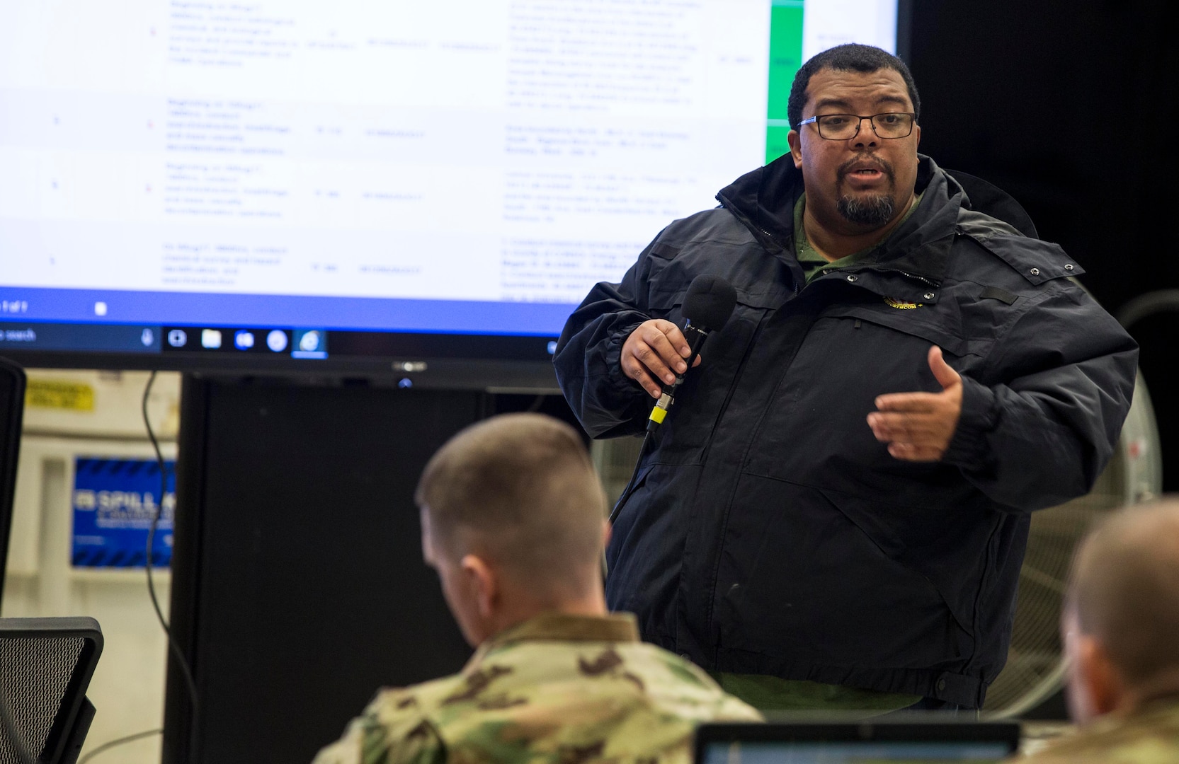 Richie Richardson, geographic information system technician, Joint Task Force Civil Support gives a brief to team members during a Joint Operations Center Exercise December 13, 2017.