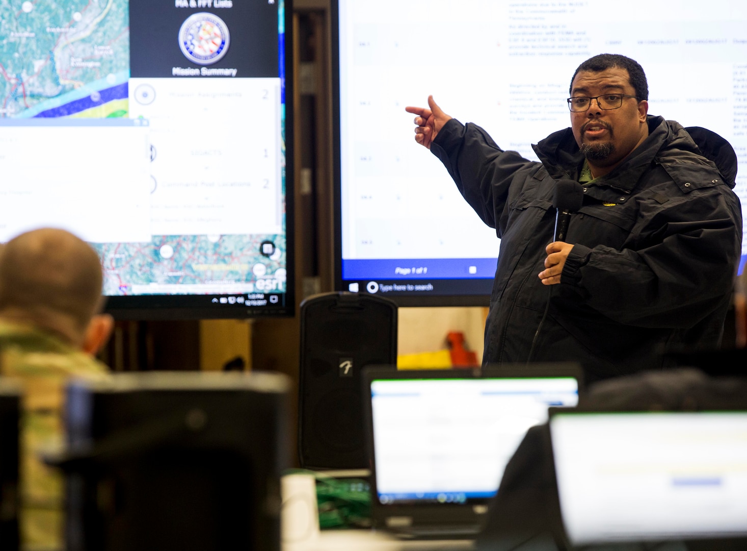 Richie Richardson, geographic information systems technician, Joint Task Force Civil Support gives a brief to team members during a Joint Operations Center Exercise December 13, 2017.