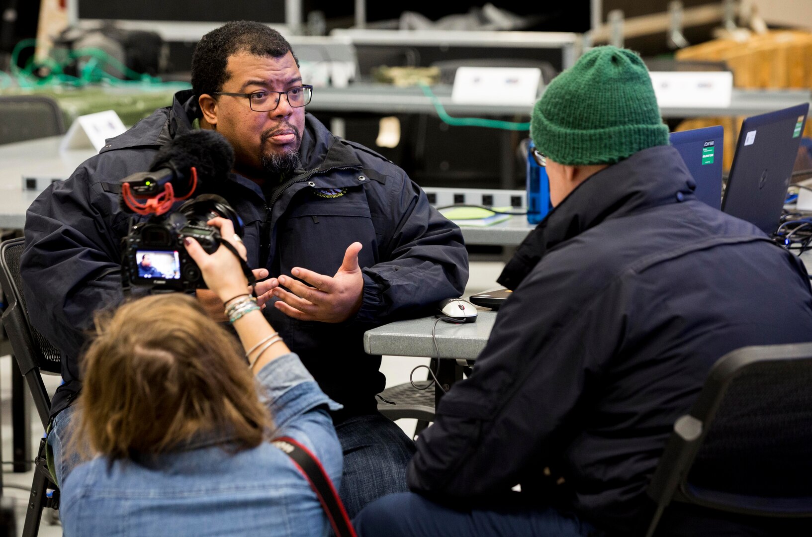 Richie Richardson, geographic information systems technician, Joint Task Force Civil Support conducts an interview with external media during a Joint Operations Center exercise December 13, 2017.