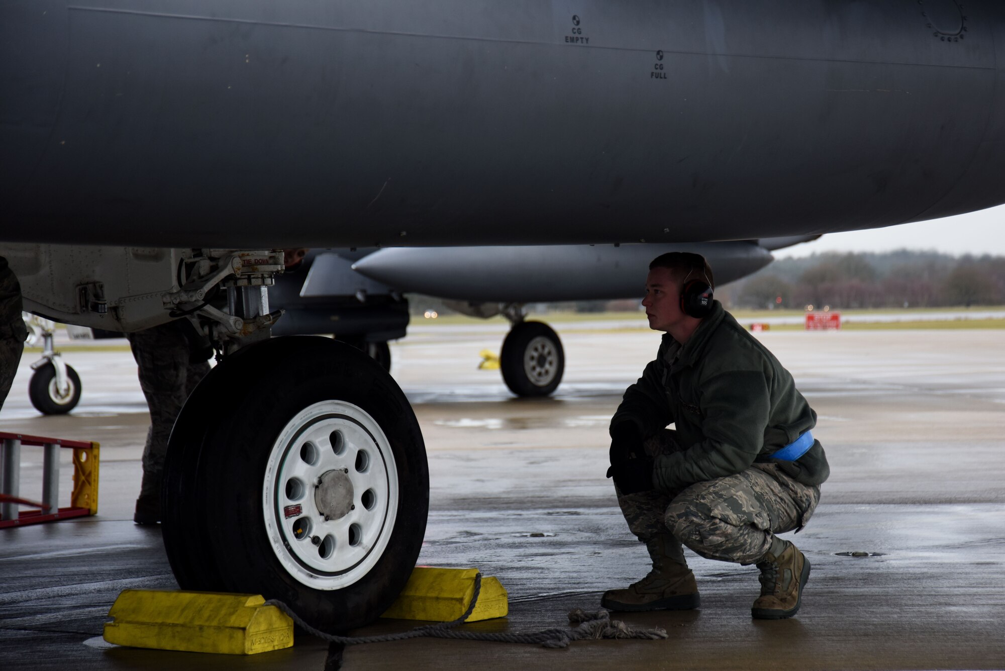 A 492nd Aircraft Maintenance Unit crew chief waits to pull the chalks for an F-15E Strike Eagle after its end-of-runway pre-takeoff inspection at Royal Air Force Lakenheath, England, Dec. 13. With five Airmen working on each aircraft, EOR inspections usually take only a few minutes to complete. (U.S. Air Force photo/Senior Airman Abby L. Finkel)