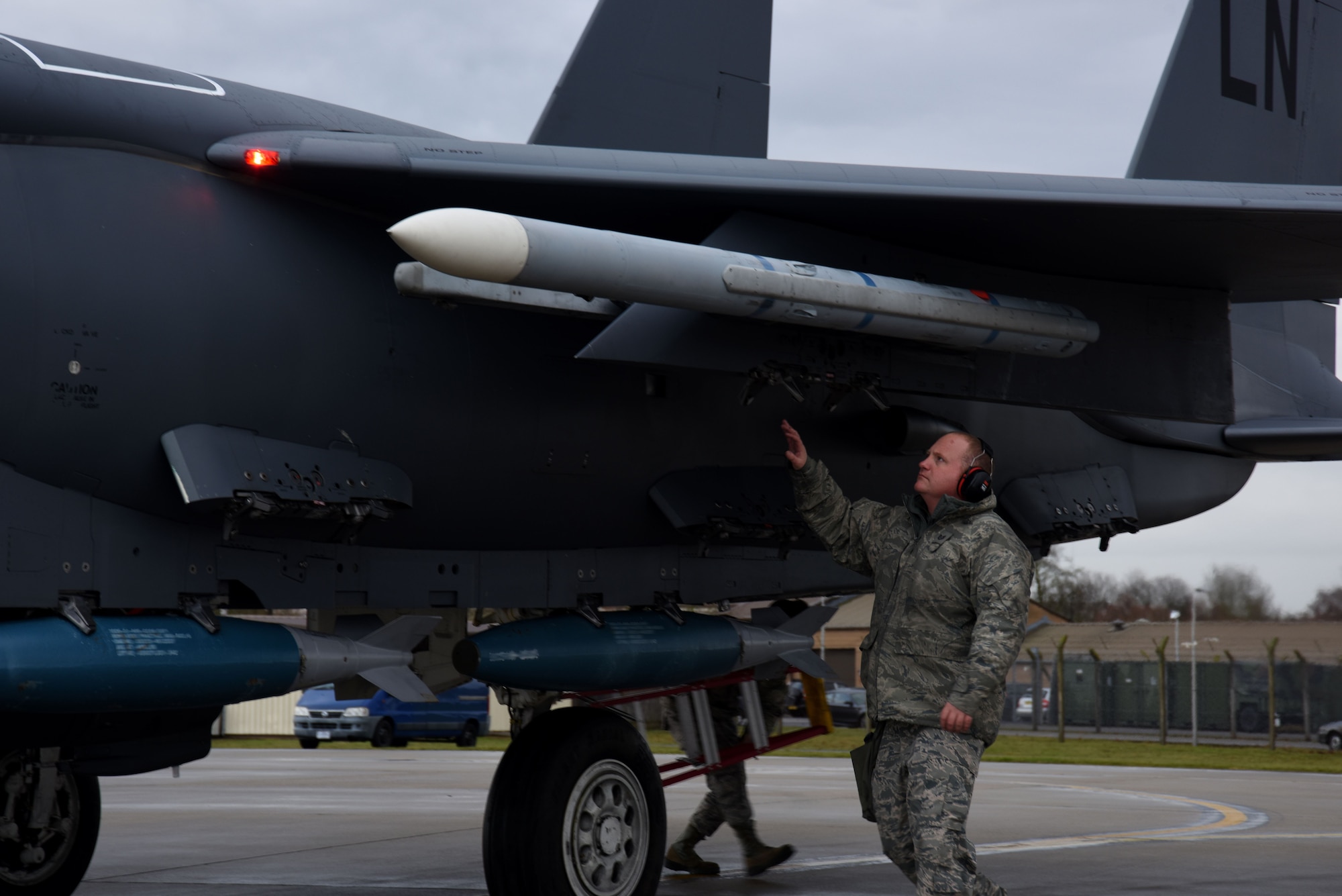 A 48th Aircraft Maintenance Squadron weapons load team chief inspects the munitions on anF-15E Strike Eagle at Royal Air Force Lakenheath, England, Dec. 13. The weapons load crew Airmen are also responsible for arming and de-arming the weapons on the aircraft. (U.S. Air Force photo/Senior Airman Abby L. Finkel)