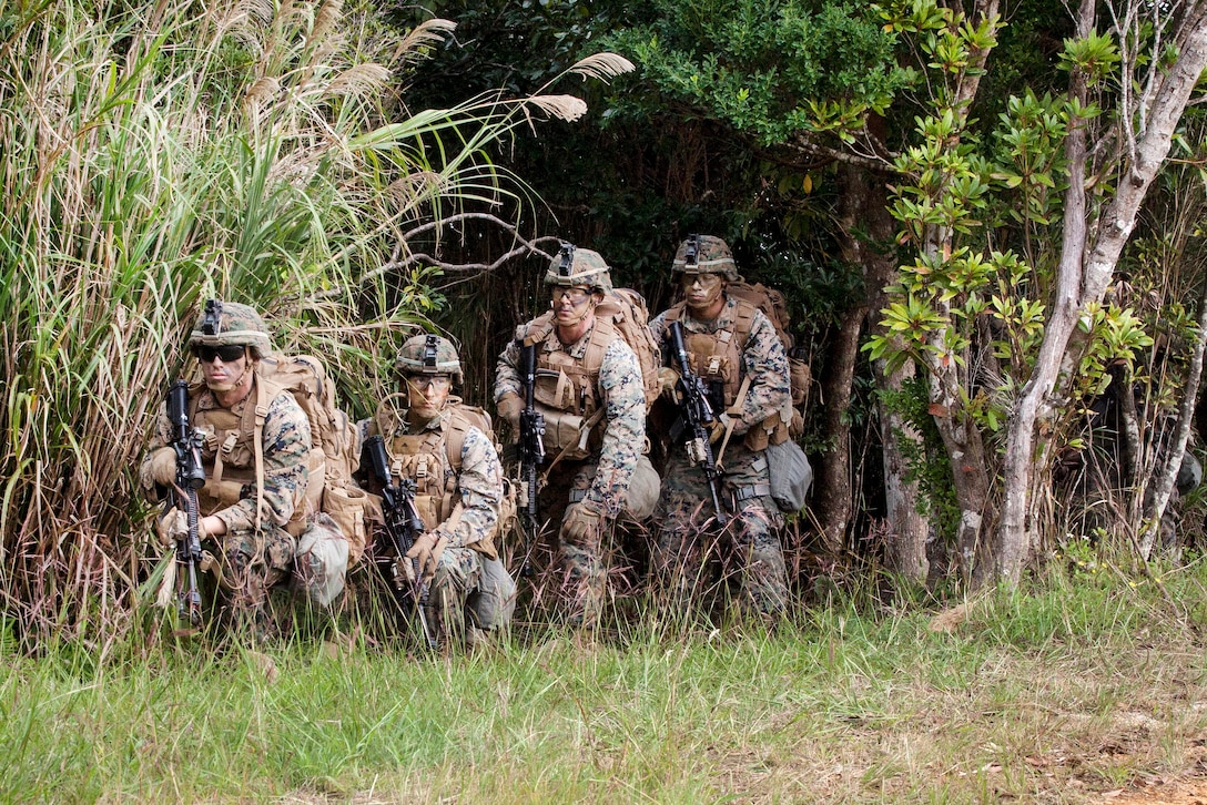 Marines provide security before moving out to their follow on objective during a motorized raid as a part of an exercise.