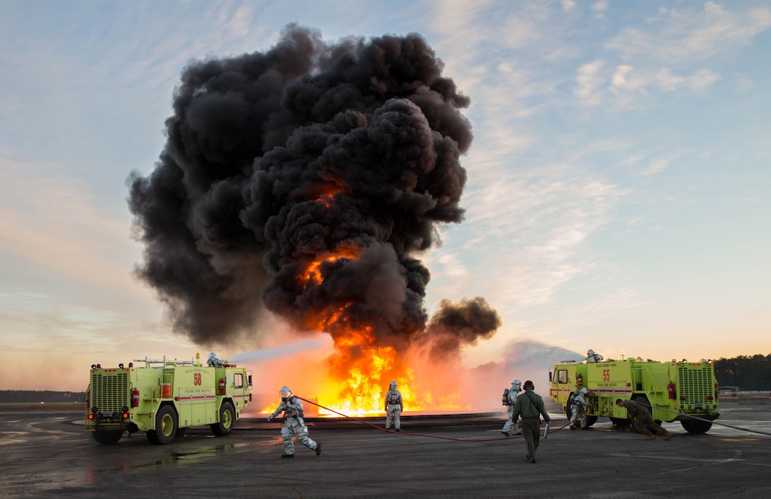 U.S. Marines with Aircraft Rescue and Firefighting (ARFF), utilize P-19 fire trucks to extinguish a fuel fire during a controlled burn exercise at Marine Corps Air Station, Cherry Point, N.C., Dec. 12, 2017. ARFF conducted the training to be greater familiarized with firefighting vehicles, controls, rescue equipment and the actions to follow in the event of an aircraft emergency.
