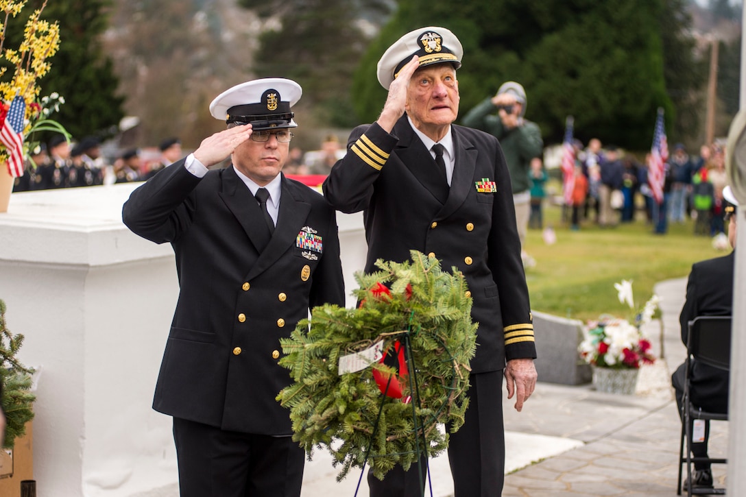 Navy Command Master Chief Petty Officer James Willis, left, command master chief of Naval Base Kitsap, Wash., and retired Navy Cmdr. Glen Brown, a World War II, Korea and Vietnam veteran, salute after placing a wreath honoring sailors at Ivy Green Cemetery's 6th annual Wreaths Across America event in Bremerton, Wash., Dec. 16, 2017. Navy photo by Petty Officer 2nd Class Wyatt L. Anthony