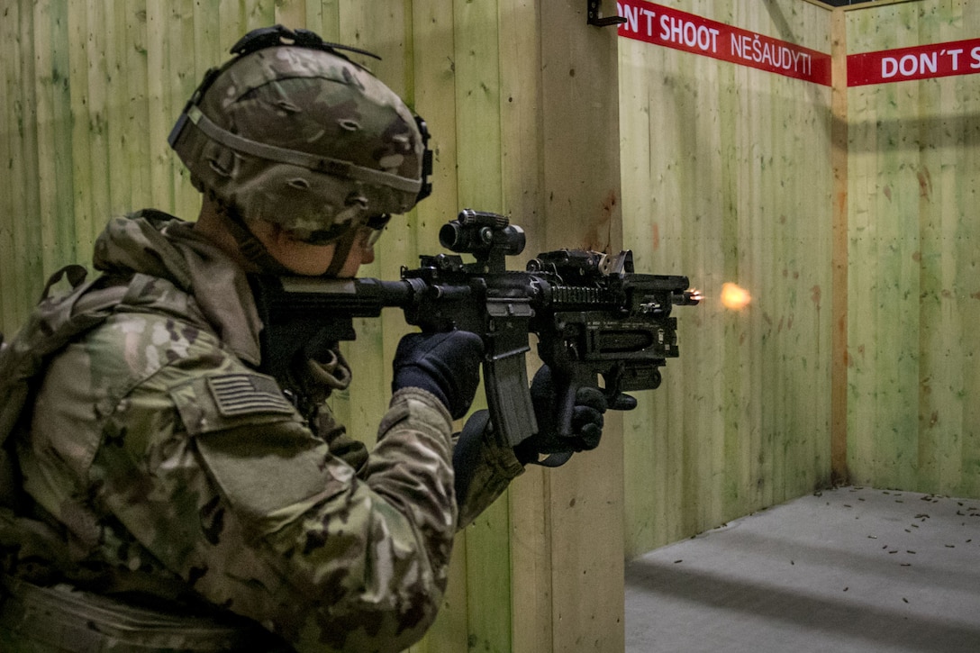 A soldier fires his gun.