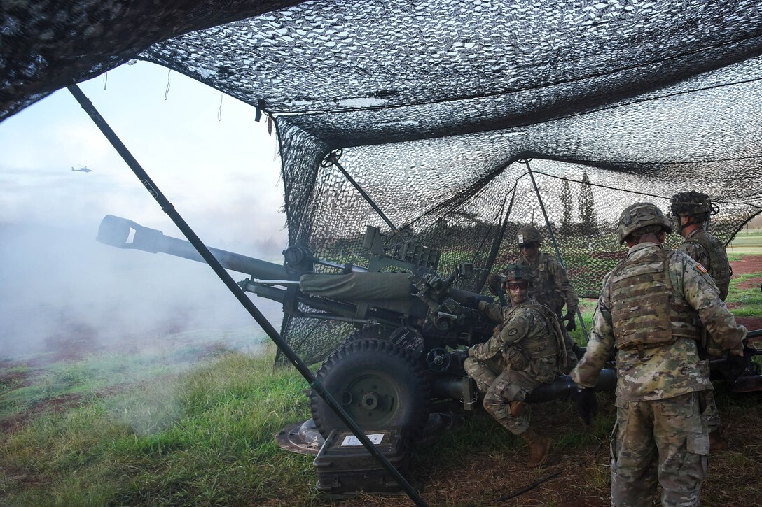 Soldiers fire a howitzer during a Combined Arms Live-Fire Exercise.