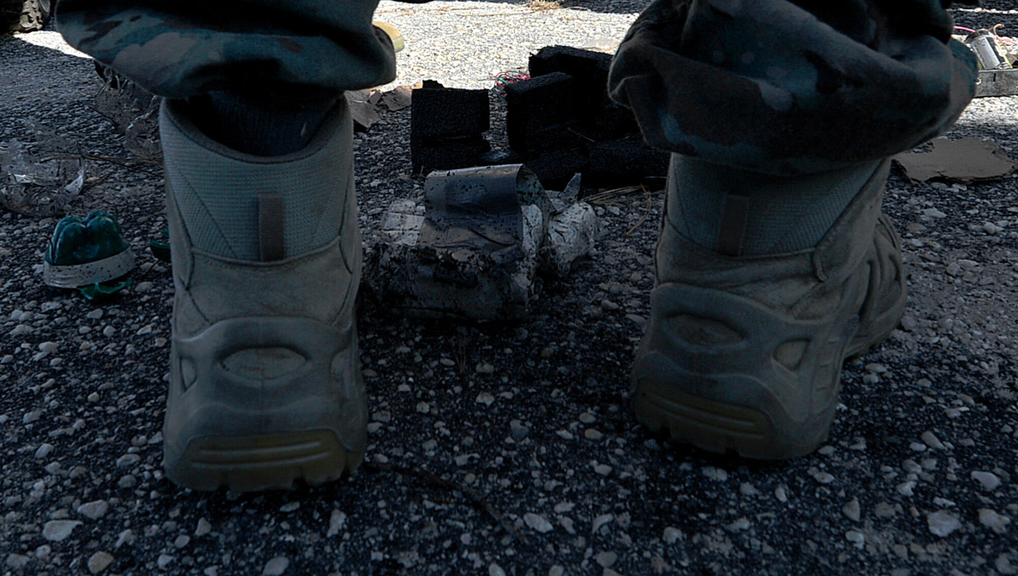 A U.S. Airman assigned to the 20th Civil Engineer Squadron explosive ordnance disposal (EOD) flight stands in front of the debris of a dummy improvised explosive device (IED) at Shaw Air Force Base, S.C., Dec. 14, 2017.