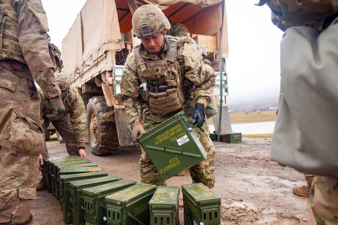 Soldiers unload ammunition.