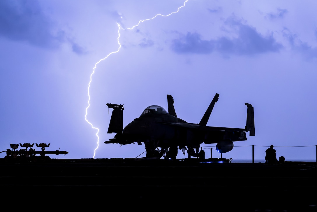 Lightning strikes near the aircraft carrier USS Theodore Roosevelt.