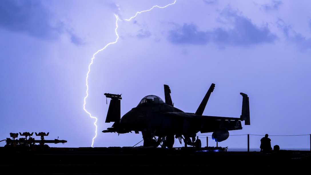 Lightning strikes near the aircraft carrier USS Theodore Roosevelt.