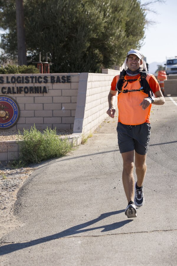Looking not in the least bit tired from the 2,800-plus miles he’s run so far, Chris Miller exits the front gate of Marine Corps Logistics Base Barstow, Calif., the morning of Dec. 5. The native of Fort Wayne, Ind., and his cousin Mike Dusman began the Chris Cross America campaign to run from coast to coast July 13 at Ellis Island, N.Y., to try and remove the stigma about drug and alcohol addiction recovery and inspire hope in those facing that scenario.