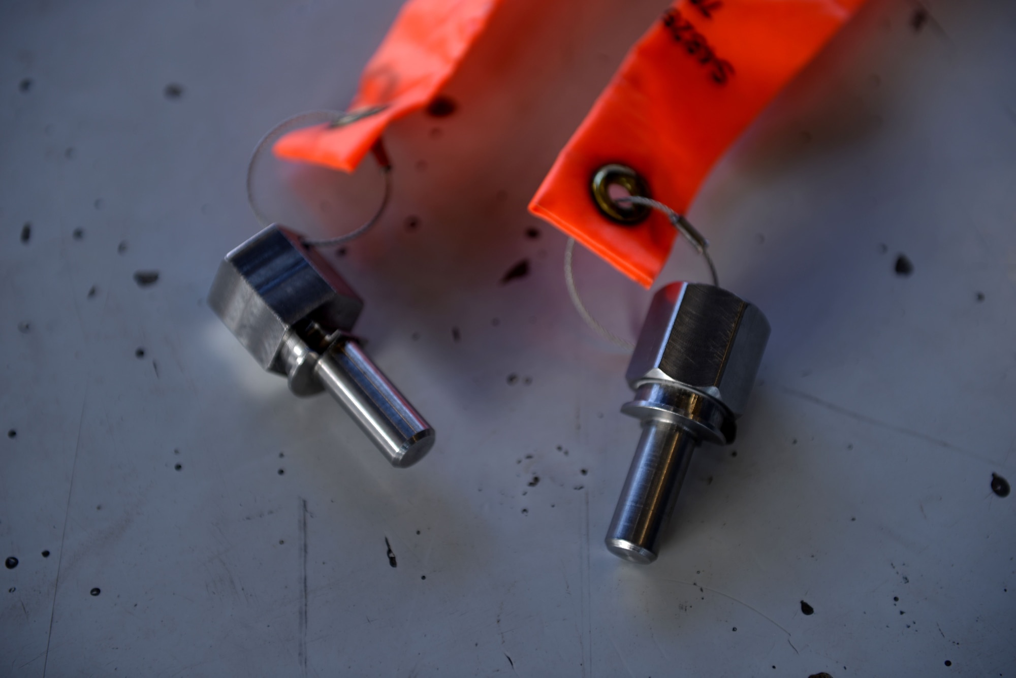 Seat raise pins sit on display during a demonstration of their capabilities in raising the ejection seat into the maintenance position on F-16 Fighting Falcons at Luke Air Force Base, Ariz., Dec. 8, 2017. The seat raise pin method will give technicians approximately eight inches of additional clearance to perform maintenance procedures eliminating the need to fully remove the seat and canopy saving many man hours. (U.S. Air Force photo/Senior Airman Ridge Shan)