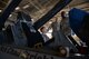 Master Sgt. Adam Peterson, 56th Component Maintenance Squadron aircrew egress systems section chief, and Senior Master Sgt. Benjamin Vanderpuy, 309th Aircraft Maintenance Unit assistant superintendent, brief Chief Master Sgt. Dominic Hemingway, 56th Maintenance Group superintendent, on procedures to lift the seat of an F-16 Fighting Falcon at Luke Air Force Base, Ariz., Dec. 8, 2017. Vanderpuy and Peterson explained the benefits of using the raise pin assembly versus the current legacy raise bar method used to suspend the ejection seat in the maintenance position. (U.S. Air Force photo/Senior Airman Ridge Shan)