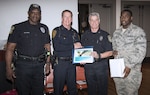 Members of the 502nd Security Forces Squadron at Joint Base San Antonio-Fort Sam Houston received a certification of appreciation for their participation in National Night Out activities during the City of San Antonio National Night Out 2017 Awards Ceremony Dec. 13 at Plaza de Armas. The certificate was awarded to the 502nd SFS by the San Antonio Police Department. Standing, from left to right, are Lt. Steven Dews, 502nd SFS crime prevention officer; Capt. James Flavin, San Antonio Police Department assistant chief; Mark Allen, 502nd SFS director; and Senior Airman Terrance Howard, 502nd SFS support staff commander.