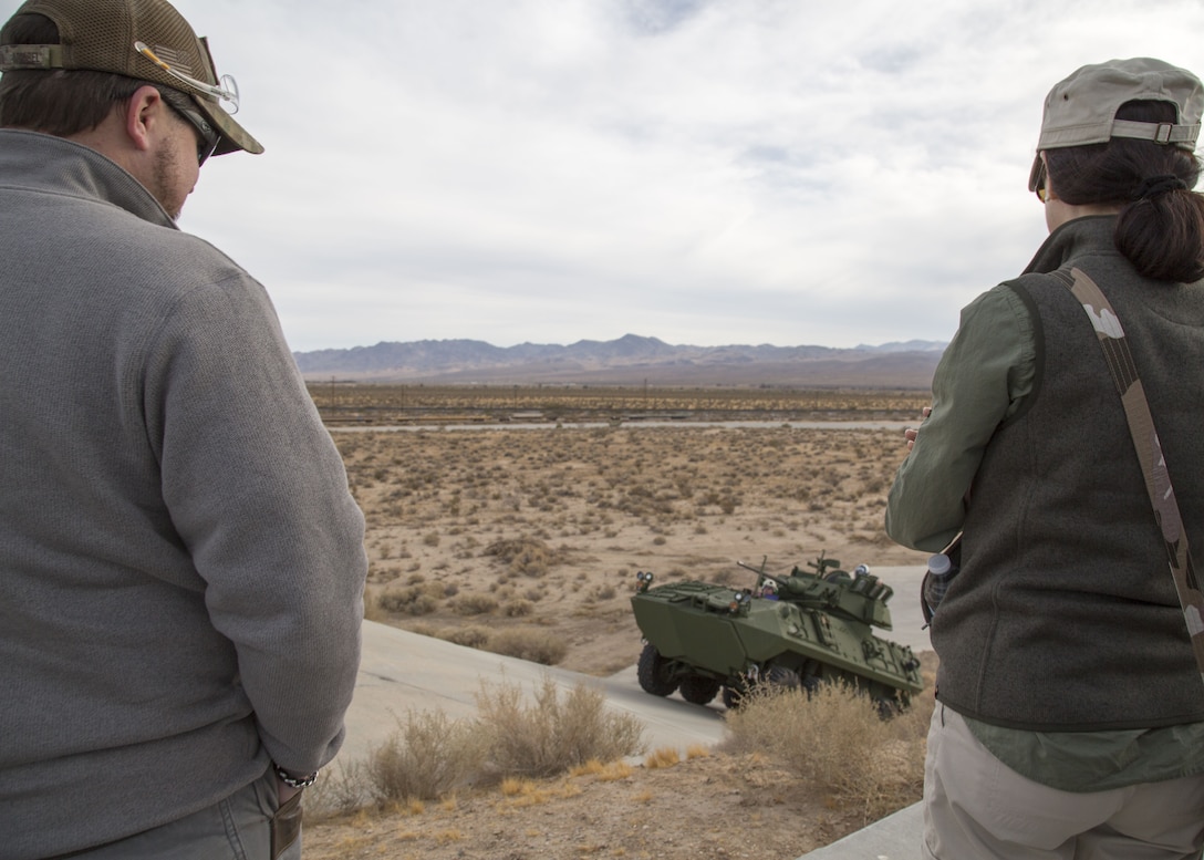 Members of the Senior Service College Fellowship Program at Defense Acquisition University observe a test track demonstration at Production Plant Barstow, Marine Depot Maintenance Command, aboard Marine Corps LogisticsBase Barstow, Calif., Nov. 30.