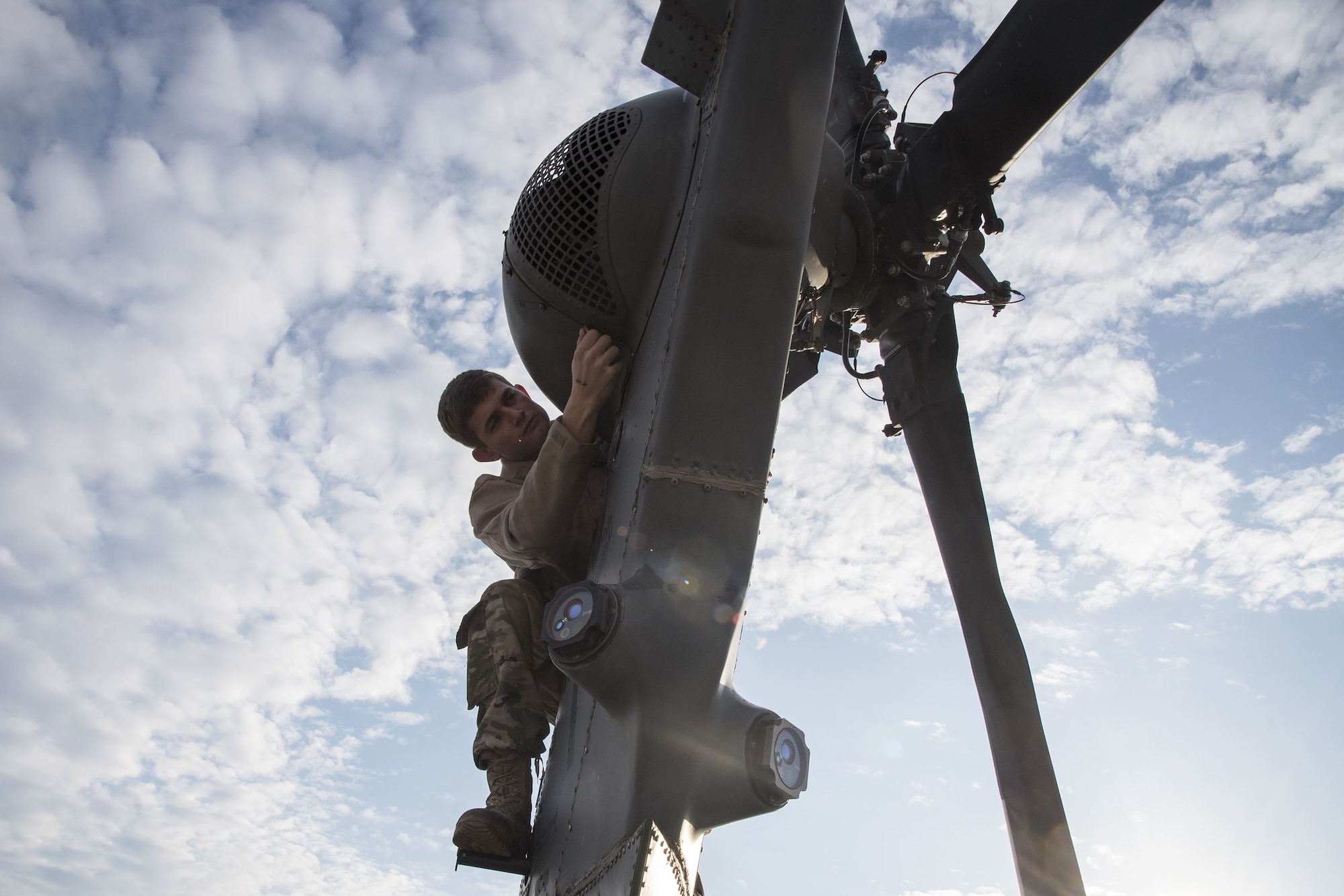 Senior Airman Travis Bauerschmidt, 723d Aircraft Maintenance Squadron (AMXS) aircraft hydraulics systems journeyman, loosens a screw on the tail rotor of an HH-60G Pave Hawk, Dec. 15, 2017, at Moody Air Force Base, Ga. Members from the 723d Aircraft Maintenance Squadron (AMXS) and 23d Civil Engineer Squadron (CES) participated in a training day to help improve their readiness and get extra practice at their crafts. The AMXS performed maintenance on helicopters and the CES conducted rescue operations by extinguishing a mock fire within an HH-60G Pave Hawk and extracting injured victims. (U.S. Air Force photo by Airman Eugene Oliver)