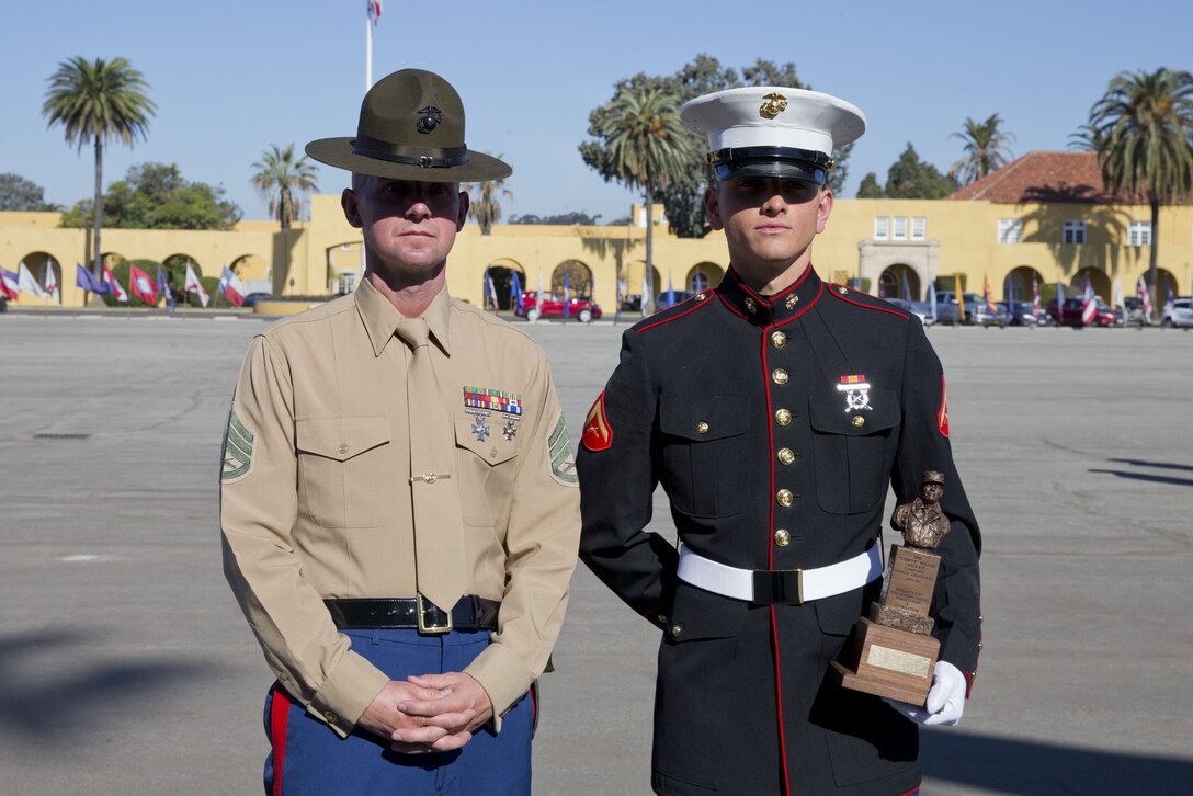 U.S. Marine Corps Lance Cpl. Tyler L. Archambeault, right, with Company F, 2d Recruit Training Battalion (2D RTBN), Recruit Training Regiment (RTR), poses for a photo with his senior drill instructor Staff Sgt Ryan. S. Jackson with Company F, 2D RTBN, RTR, after a graduation ceremony at Marine Corps Recruit Depot San Diego, Calif., Dec. 15, 2017. Archambeault received the Chesty Puller award and was named company honor graduate from Company F, 2D RTBN. (U.S. Marine Corps photo by Lance Cpl. Alexander L. Gist)