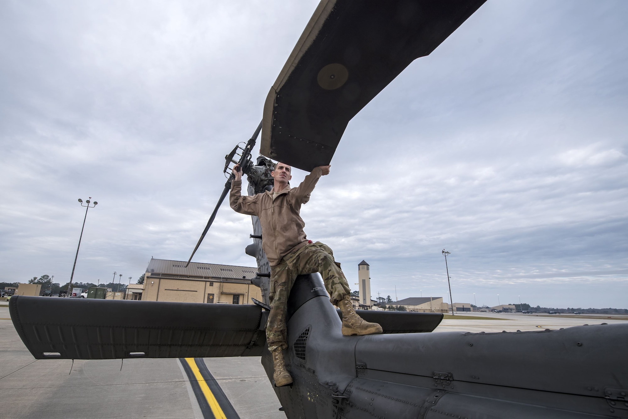 Staff Sgt. Dustin Stephens, 723d Aircraft Maintenance Squadron (AMXS) crew chief, pulls the rotors of an HH-60G Pave Hawk, Dec. 15, 2017, at Moody Air Force Base, Ga. Members from the 723d Aircraft Maintenance Squadron (AMXS) and 23d Civil Engineer Squadron (CES) participated in a training day to help improve their readiness and get extra practice at their crafts. The AMXS performed maintenance on helicopters and the CES conducted rescue operations by extinguishing a mock fire within an HH-60G Pave Hawk and extracting injured victims. (U.S. Air Force photo by Airman Eugene Oliver)