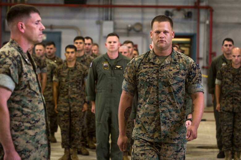 Sgt. Ethan Mintus, an unmanned aerial system (UAS) operator with Marine Unmanned Aerial Vehicle Squadron 3 (VMU-3), marches forward during an award ceremony at Hangar 103, Marine Corps Air Station Kaneohe Bay, Dec. 11, 2017. Mintus was awarded the Navy and Marine Corps Achievement Medal with the newly authorized Remote Impact (“R”) Device alongside Sgt. Joseph Latsch, a fellow UAS operator with VMU-3, for their performance during combat operations. (U.S. Marine Corps photo by Lance Cpl. Isabelo Tabanguil)