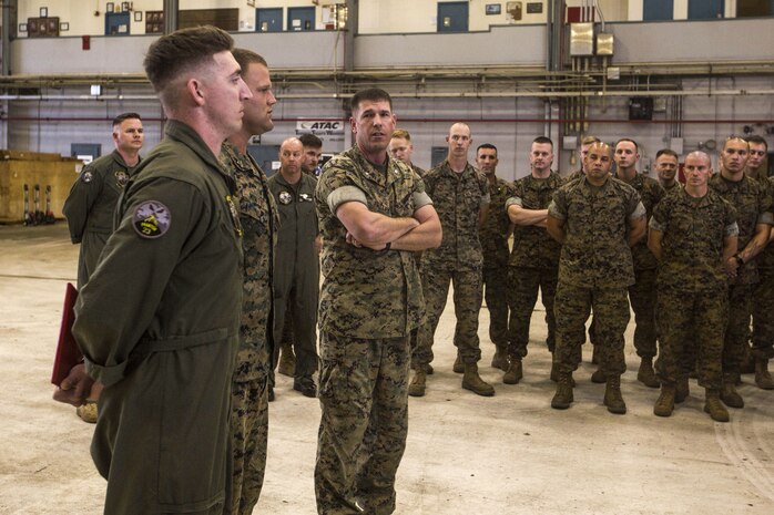 Lt. Col. Kenneth Phelps, the commanding officer of Marine Unmanned Aerial Vehicle Squadron 3 (VMU-3), recognizes Sgt. Joseph Latsch and Sgt. Ethan Mintus, unmanned aerial system (UAS) operators with VMU-3, after an award ceremony at Hangar 103, Marine Corps Air Station Kaneohe Bay, Dec. 11, 2017. Latsch and Mintus are the first UAS operators in the Marine Corps to receive a Navy and Marine Corps Achievement Medal with the newly authorized Remote Impact (“R”) Device for providing support during combat operations. (U.S. Marine Corps photo by Lance Cpl. Isabelo Tabanguil)