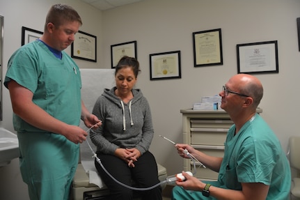 Army Lt. Col. (Dr.) Shane McEntire, a vascular surgeon at Brooke Army Medical Center, shows the device used to perform the TransCarotid Artery Revascularization procedure to Air Force Maj. (Dr.) William Harris, vascular surgeon, and DeAnn Yanez, a nurse in the vascular surgery clinic, Dec. 12, 2017. Surgeons must be specially trained or assisted by someone who has been trained on the device used during the TCAR procedure before they can do this surgery.