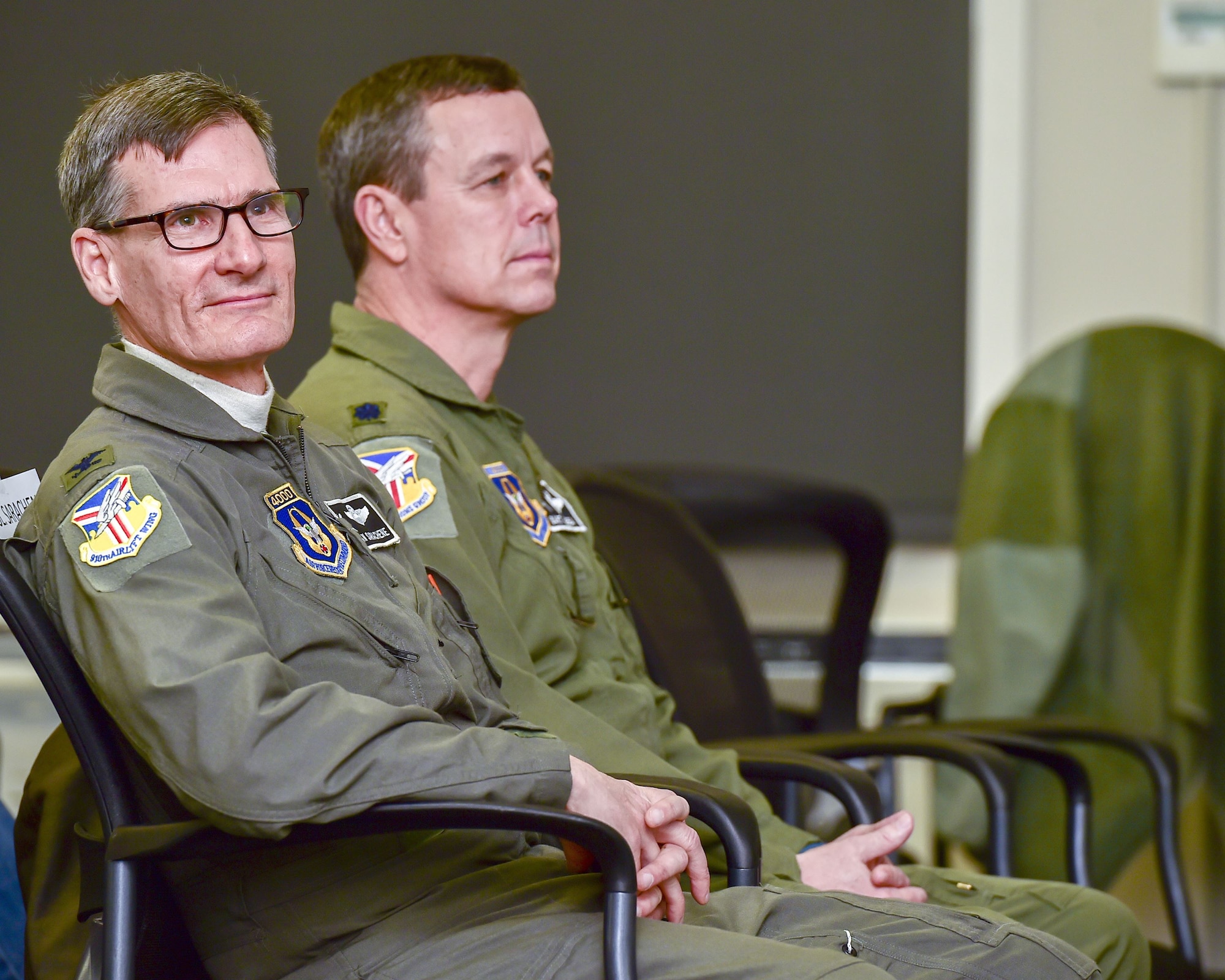 Col. Dan Sarachene, 910th Airlift Wing commander, and Lt. Col. Bart Elsea, 910th Airlift Wing Operations Group commander, listen as David Kubli, son of Fred Jr. and Laverne Kubli, gives remarks during a building dedication ceremony honoring Fred here, Dec. 15, 2017.
