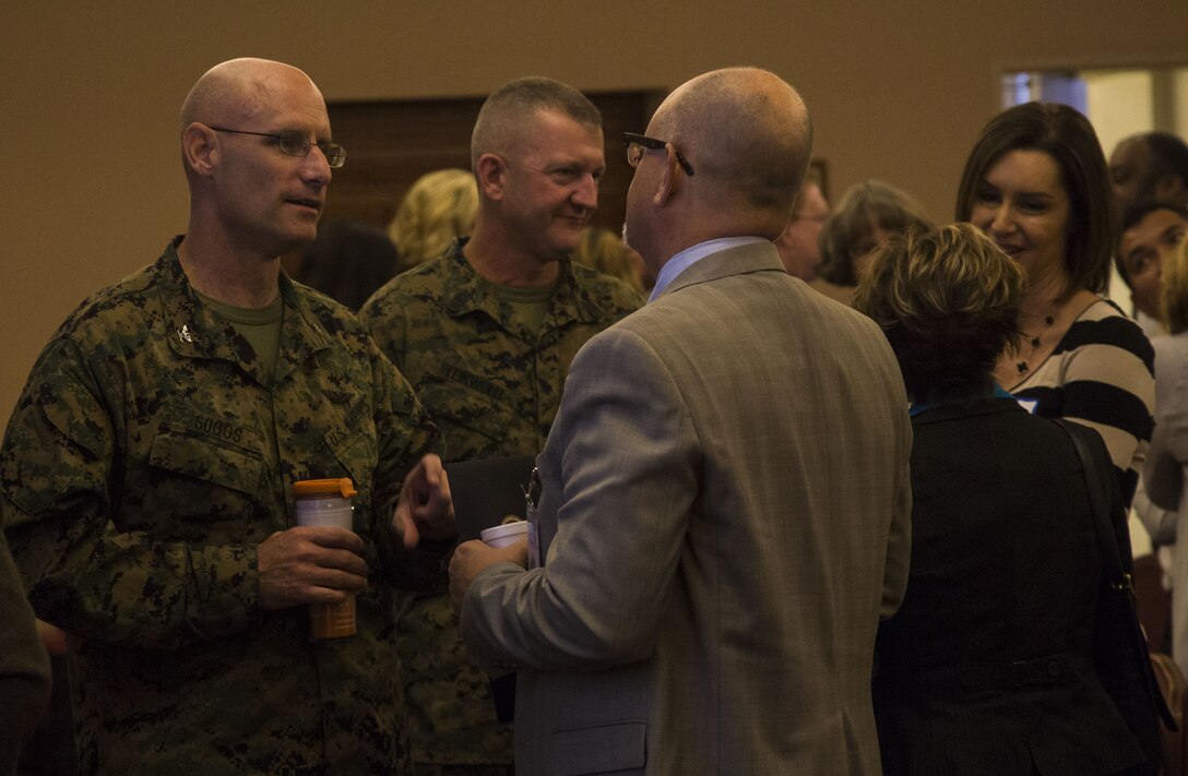 U.S. Marine Corps Col. David A. Suggs, the commanding officer of Marine Corps Air Station (MCAS) Yuma, speaks to James Sheldahl, the superintendent of Yuma School District One, during the Military K-12 Education Meet and Greet at the Sonoran Pueblo on MCAS Yuma, Ariz., Nov. 29, 2017. Yuma educational leaders received a brief on the air station's mission and how its continuing growth will impact their schools.
