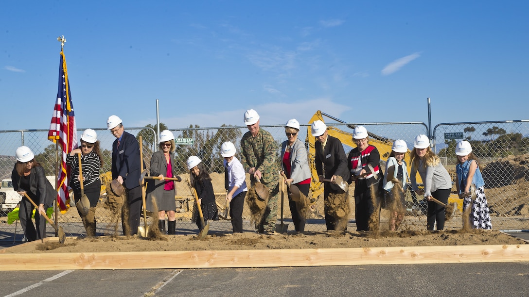 San Onofre Elementary School students, Marine Corps Installations-West chief of staff, Colonel Joseph D. Williams,  and Fallbrook School Board members, break ground at the new San Onofre Elementary School site aboard Camp Pendleton, Calif., Dec. 14, 2017. The new school will enroll 900 students, have computer labs with wireless internet, and an improved science, technology, engineering, mathematics program. (U.S. Marine Corps photo by Pfc. Drake Nickels)