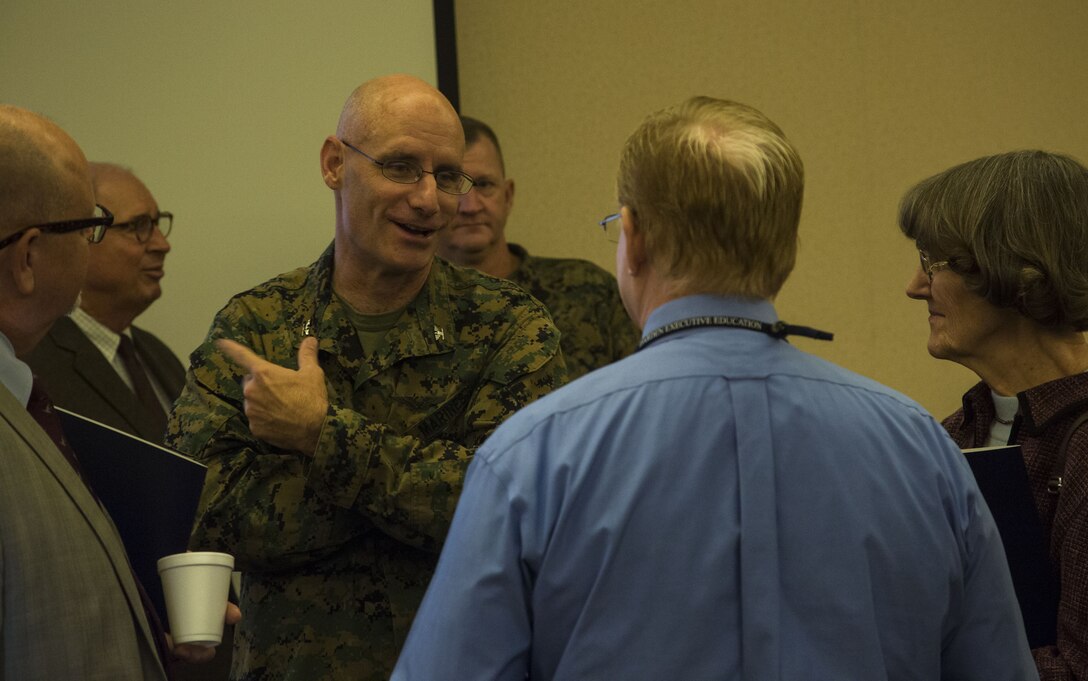 U.S. Marine Corps Col. David A. Suggs, the commanding officer of Marine Corps Air Station (MCAS) Yuma, speaks to Duane Sheppard, the assistant superintendent of Yuma School District One, during the Military K-12 Education Meet and Greet at the Sonoran Pueblo on MCAS Yuma, Ariz., Nov. 29, 2017. Yuma educational leaders received a brief on the air station's mission and how its continuing growth will impact their schools.