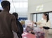 A Project Toy Drop volunteer hands bags full of toys to event participants during Maxwell’s Project Toy Drop, Dec. 16, 2017, Maxwell Air Force Base, Ala.  Project Toy Drop travels around the country and delivers toys to children of American service members or at-risk youth.  (U.S. Air Force photo by Daniella Peña)