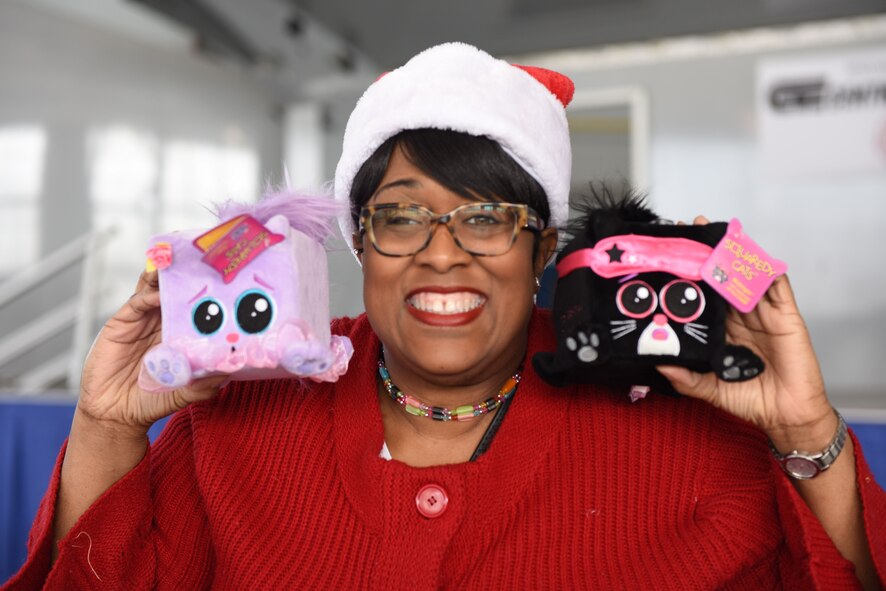 A Project Toy Drop volunteer shows some of the toys being given out during Maxwell’s Project Toy Drop, Dec. 16, 2017, Maxwell Air Force Base, Ala.  Project Toy Drop offers many volunteer opportunities throughout the country.    (U.S. Air Force photo by Daniella Peña)
