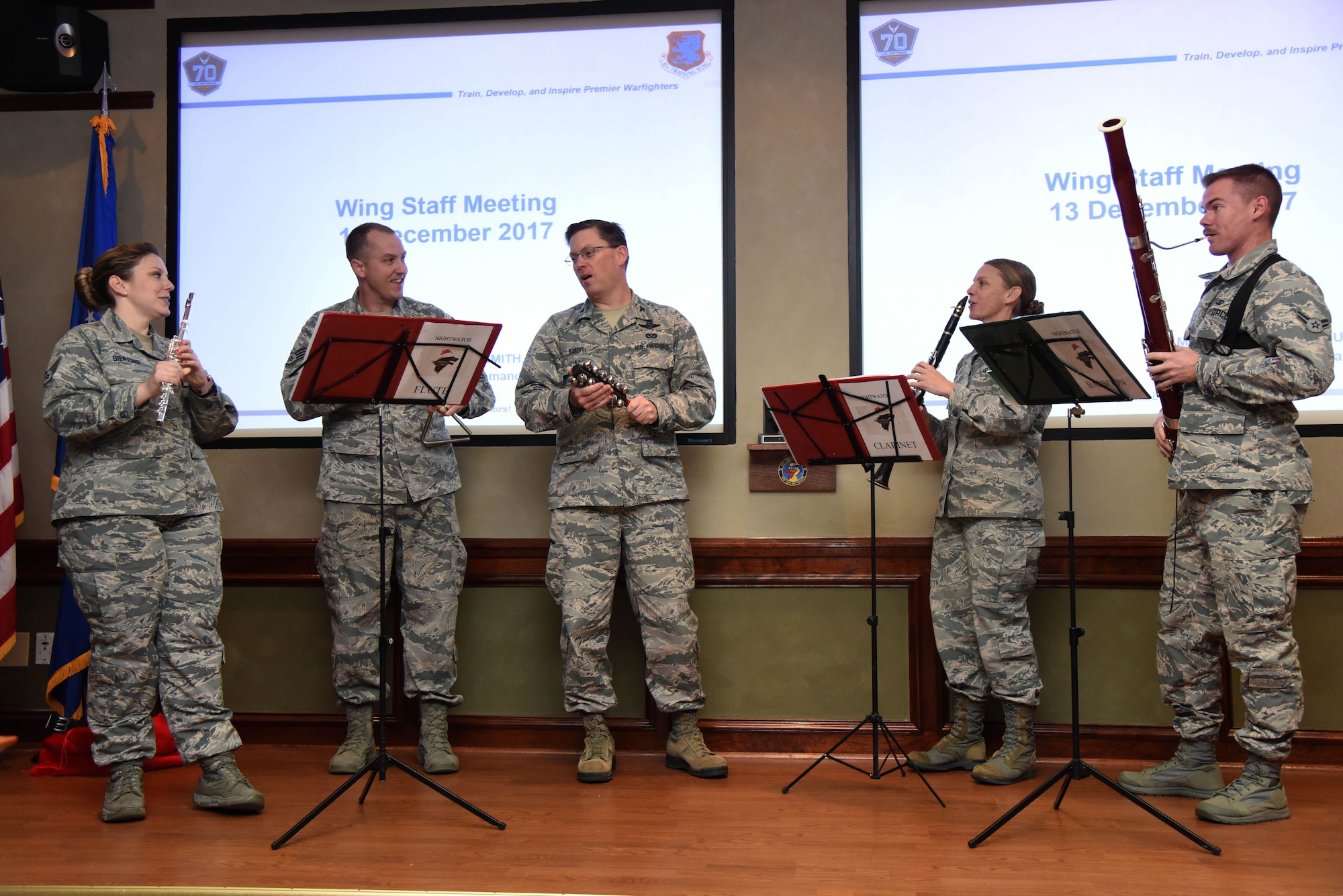 Col. C. Mike Smith, 81st Training Wing vice commander, performs a song with The U.S. Air Force Band of the West, Nightwatch, during the 81st Training Wing staff meeting at Stennis Hall Dec. 13, 2017, on Keesler Air Force Base, Mississippi. During the two-day visit to Keesler the band performed for Airmen and local residents throughout various locations at Keesler and the nearby area. Their mission is to honor military heritage through music, connect with the American public and inspire patriotism and excellence. (U.S. Air Force photo by Kemberly Groue)