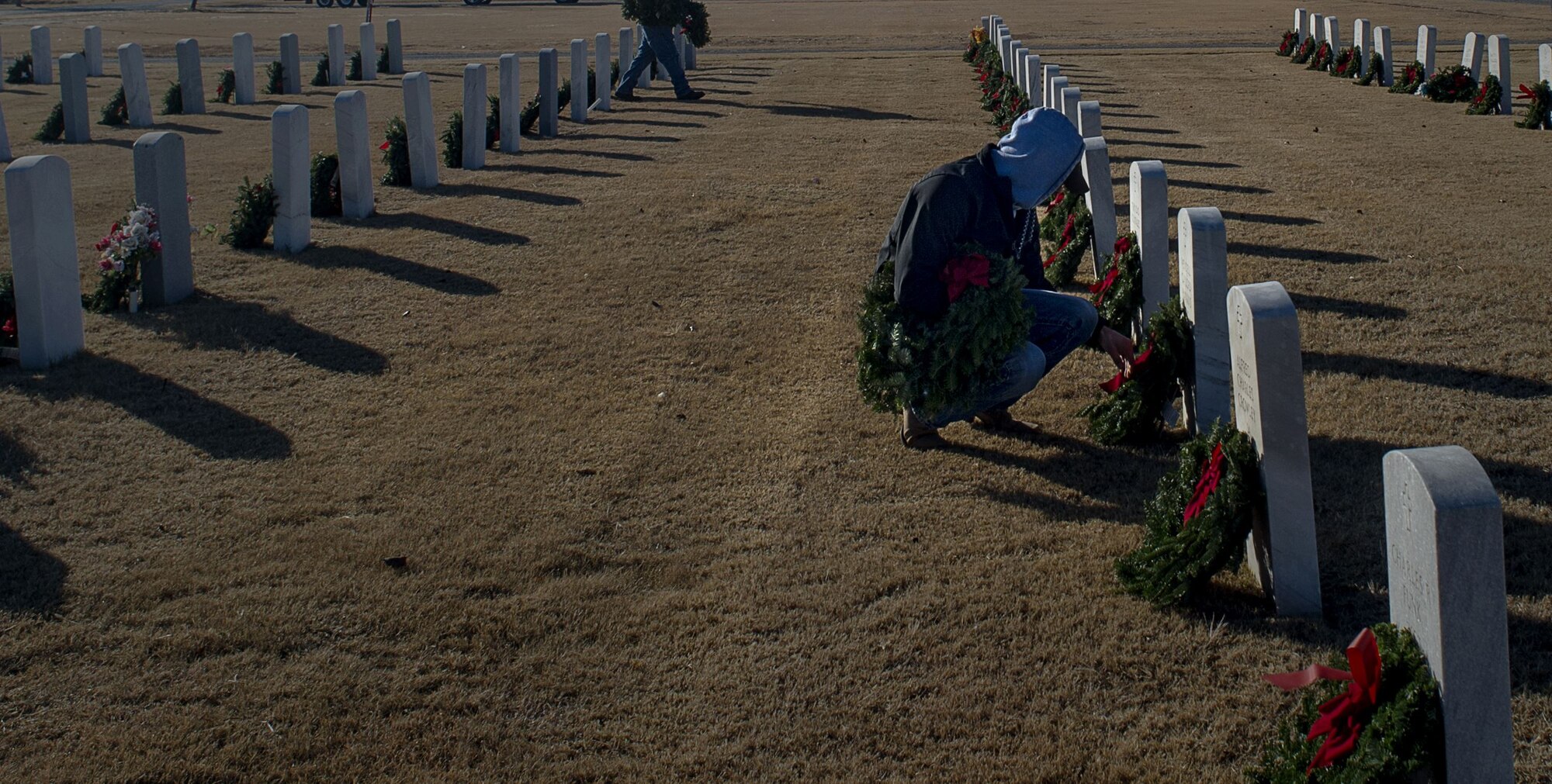 Volunteers from the local community place wreaths on veteran's graves during a Wreaths Across America ceremony at the Altus Cemetery, Okla., Dec. 16, 2017.