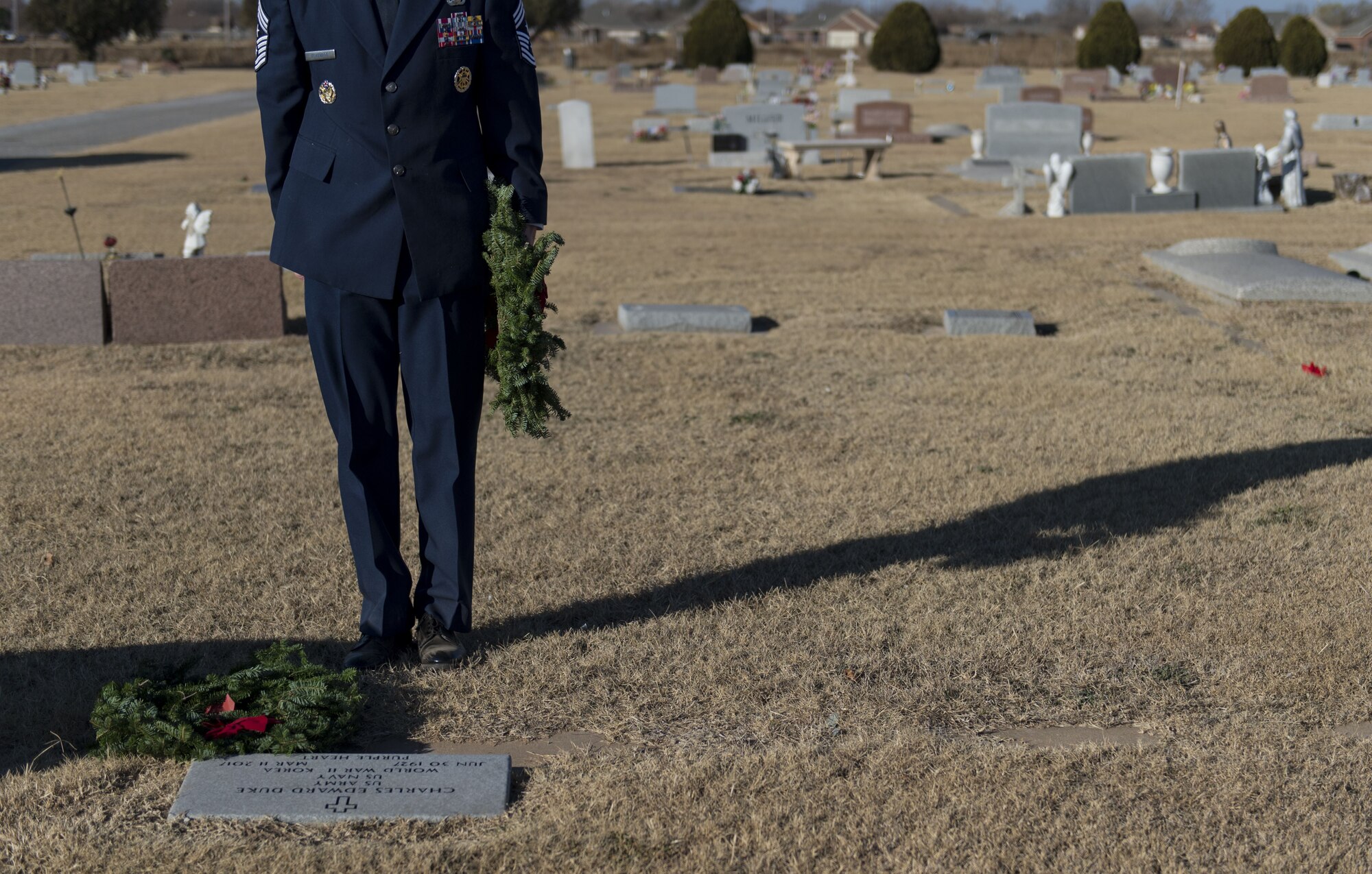 U.S. Air Force Chief Master Sgt. Philip Eckenrod Jr., Command Chief assigned to the 97th Air Mobility Wing, places a wreath on a veterans' grave during a Wreaths Across America ceremony at the Altus Cemetery, Okla., Dec. 16, 2017.
