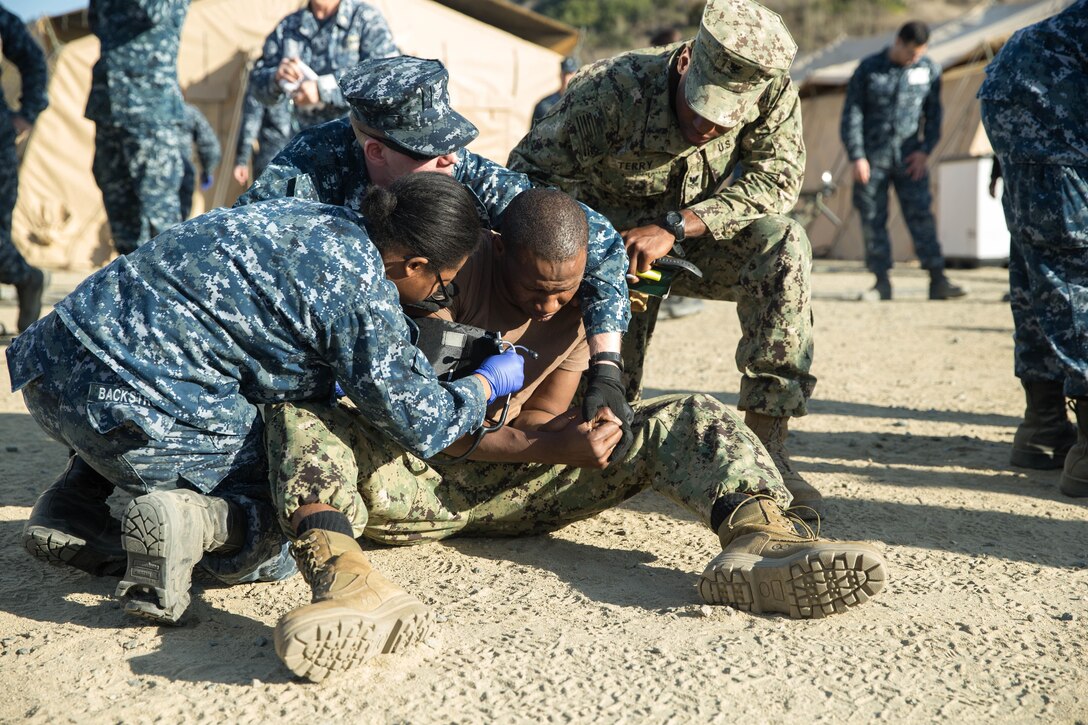 Naval medical personnel, both active duty and reservists from various bases, participated in Expeditionary Medical Facility Training aboard Camp Pendleton, Calif., Dec. 11-15, 2017.  The training facility, constructed of tents, included a 50-bed field hospital with an intensive care unit, operation room capabilities and ambulatory care.  Participants ran through scenarios and practiced treated "casualties" in a simulated combat environment.  (U. S. Marine Corps photo by Lance Cpl. Haley McMenamin)