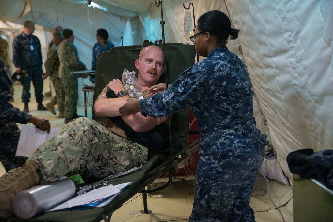 Naval medical personnel, both active duty and reservists from various bases, participated in Expeditionary Medical Facility Training aboard Camp Pendleton, Calif., Dec. 11-15, 2017.  The training facility, constructed of tents, included a 50-bed field hospital with an intensive care unit, operation room capabilities and ambulatory care.  Participants ran through scenarios and practiced treated "casualties" in a simulated combat environment.  (U. S. Marine Corps photo by Lance Cpl. Haley McMenamin)