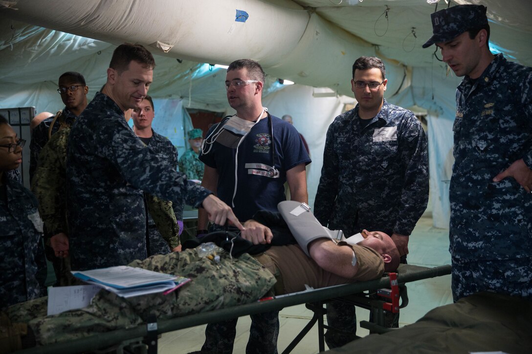 Naval medical personnel, both active duty and reservists from various bases, participated in Expeditionary Medical Facility Training aboard Camp Pendleton, Calif., Dec. 11-15, 2017.  The training facility, constructed of tents, included a 50-bed field hospital with an intensive care unit, operation room capabilities and ambulatory care.  Participants ran through scenarios and practiced treated "casualties" in a simulated combat environment.  (U. S. Marine Corps photo by Lance Cpl. Haley McMenamin)