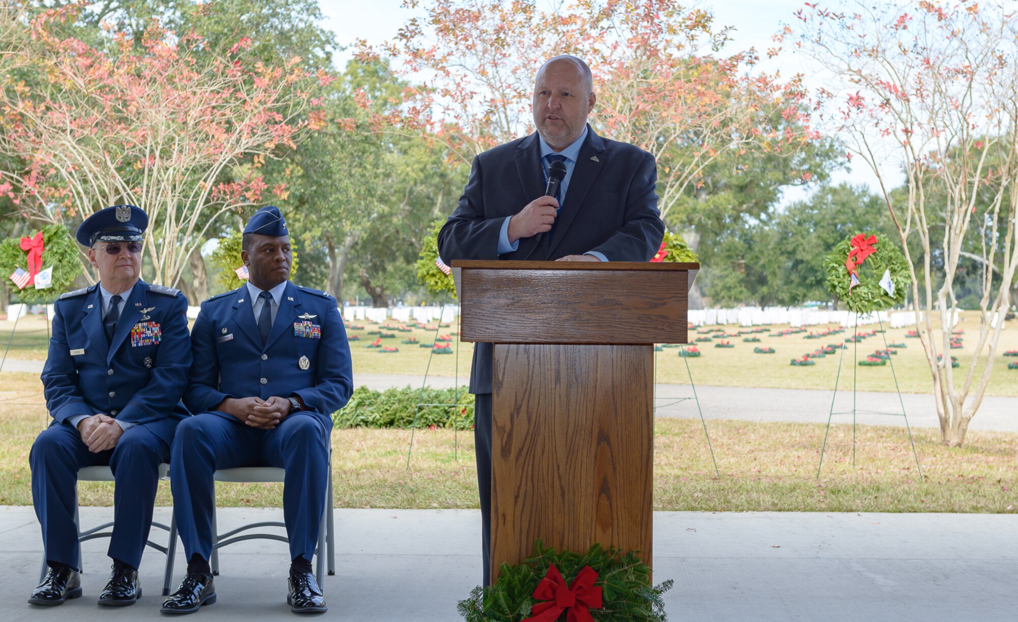 U.S. Army retired Chief Warrant Officer Shawn Hamner, Biloxi National Cemetery director, delivers comments during the Wreaths Across America ceremony at the Biloxi National Cemetery Dec. 16, 2017, in Biloxi, Mississippi. Wreaths Across America, a non-profit organization, was formed as an extension of the Arlington Wreath Project. The Arlington Wreath program was started by Morrill Worcester in 1992 with the donation and laying of 5000 Christmas wreaths to Arlington National Cemetery. (U.S. Air Force photo by André Askew)