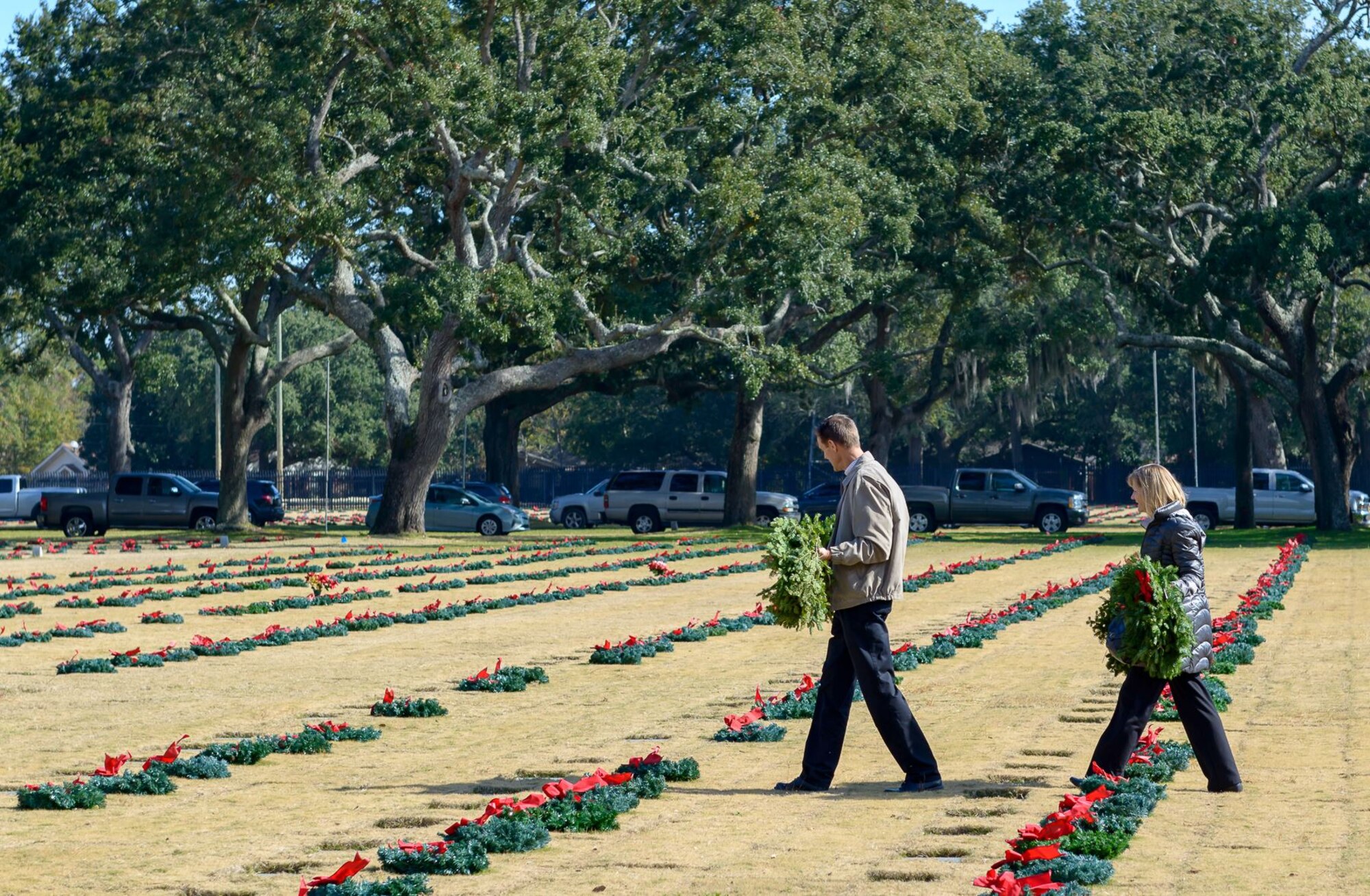 Local volunteers place wreaths at headstones during the Wreaths Across America ceremony at the Biloxi National Cemetery Dec. 16, 2017, in Biloxi, Mississippi. Wreaths Across America, a non-profit organization, was formed as an extension of the Arlington Wreath Project. The Arlington Wreath program was started by Morrill Worcester in 1992 with the donation and laying of 5000 Christmas wreaths to Arlington National Cemetery. Keesler leadership attended the event. (U.S. Air Force photo by André Askew)