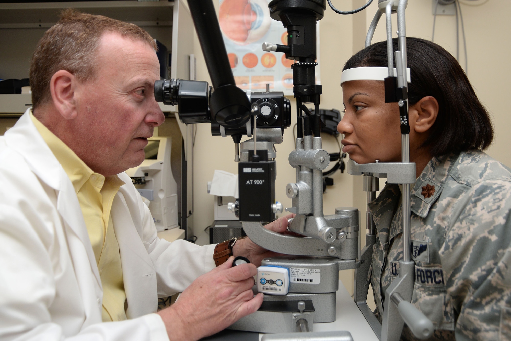 Dr. James Rux, 81st Surgical Operations Squadron Ophthalmology Clinic doctor of ophthalmology, performs an eye exam on Maj. Arian Moses, 81st MSGS Ophthalmology Clinic flight commander, Dec. 8, 2017, on Keesler Air Force Base, Mississippi. The clinic was made as part of a warfighter program, which is designed to get active duty members prepared for deployment without the liability of having contact lenses or glasses. (U.S. Air Force photo by Airman 1st Class Suzanna Plotnikov)