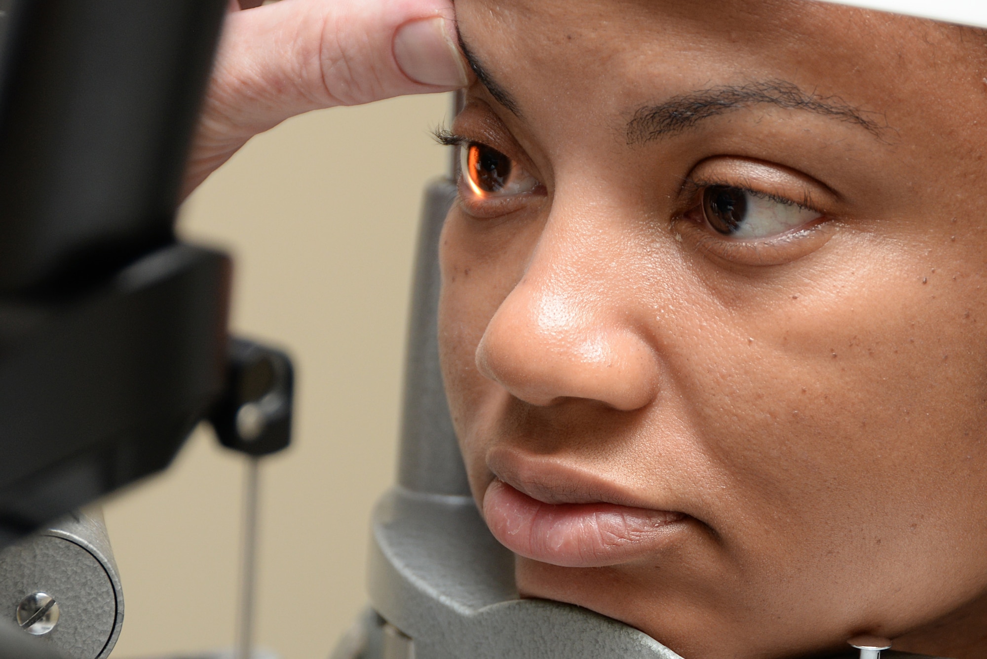 Maj. Arian Moses, 81st Surgical Operations Squadron Ophthalmology Clinic flight commander, receives an eye exam Dec. 8, 2017, on Keesler Air Force Base, Mississippi. The clinic was made as part of a warfighter program, which is designed to get active duty members prepared for deployment without the liability of having contact lenses or glasses. (U.S. Air Force photo by Airman 1st Class Suzanna Plotnikov)