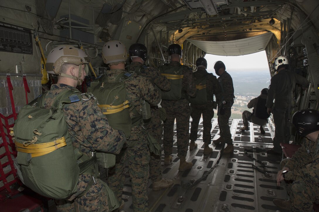 Marines with 3rd Force Reconnaissance Company, 4th Marine Division, Marine Forces Reserve, line up before performing a static line jump at Stennis Space Center in Hancock County, Mississippi, Dec. 14, 2017.