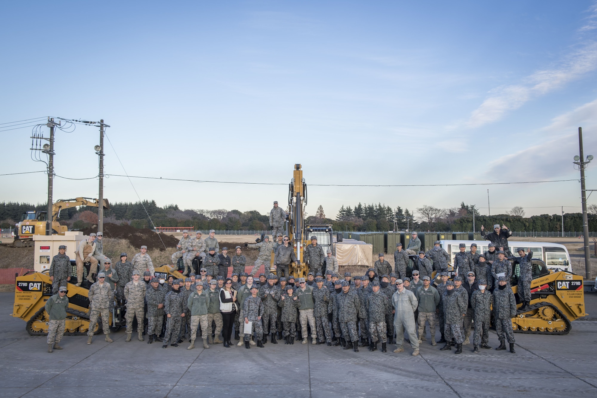 Koku Jietai (Japan Air Self-Defense Force) engineers pose for a photo with U.S. Air Force Airmen from the 374th Civil Engineer Squadron after a day of bilateral training, Dec. 12, 2017, at Yokota Air Base, Japan.